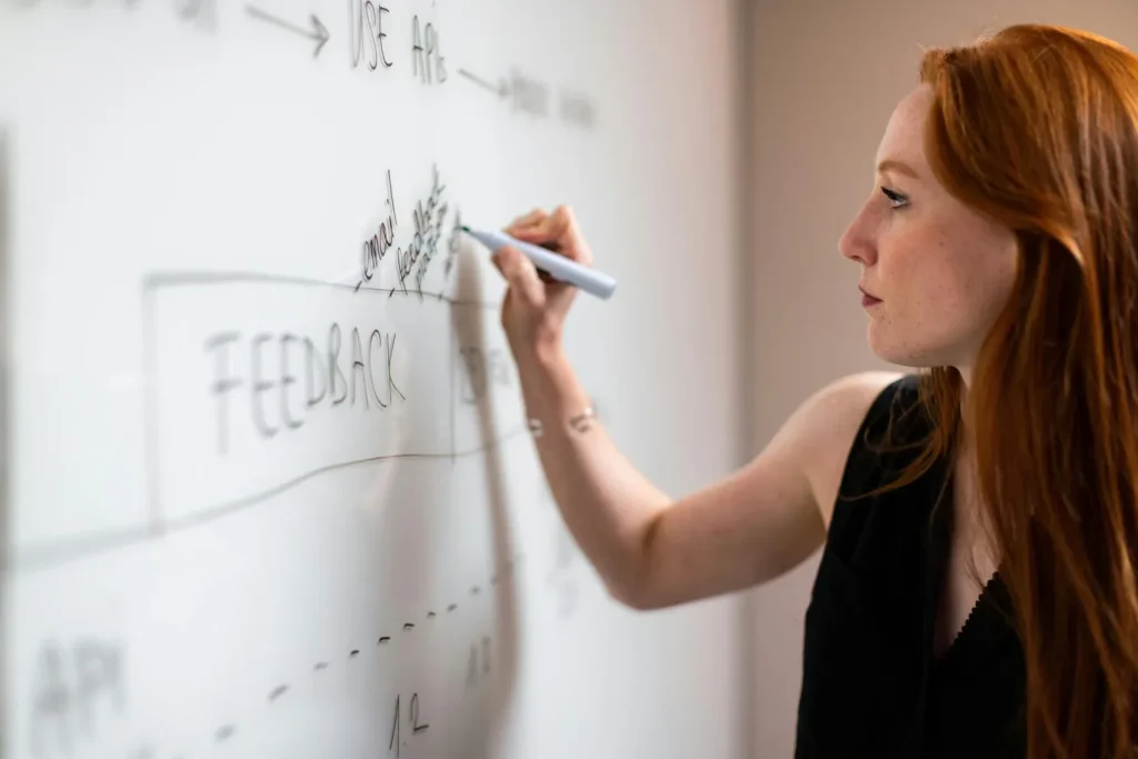 Woman writing on whiteboard